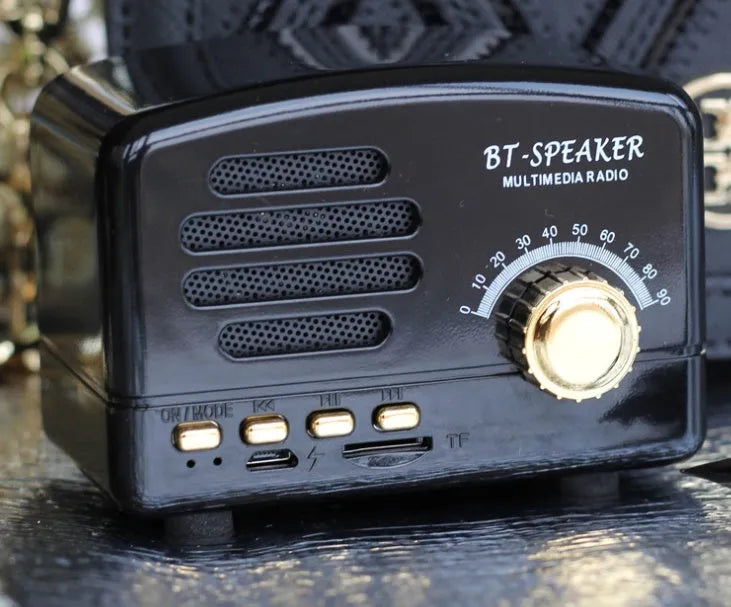 Vintage wood Bluetooth speaker in pink, black, and wood grain colours showing compact 93mm design