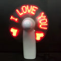 White handheld mini fan with blue and red LED lights flashing a love message pattern