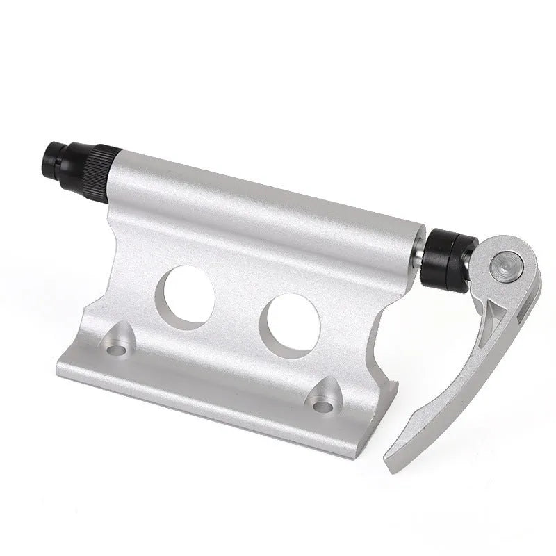 Silver metal quick release clamp for attaching a rack to a bicycle front fork.