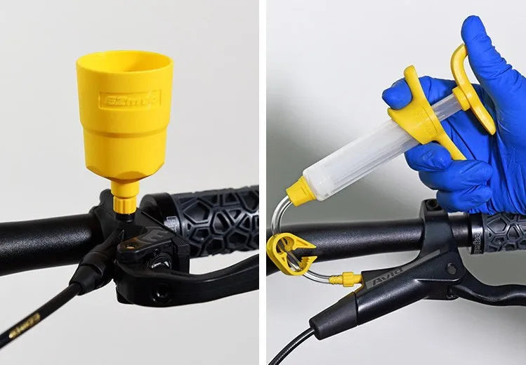 EZmtb bicycle hydraulic brake bleed kit showing syringes, funnels, adapters, and wrenches on a table