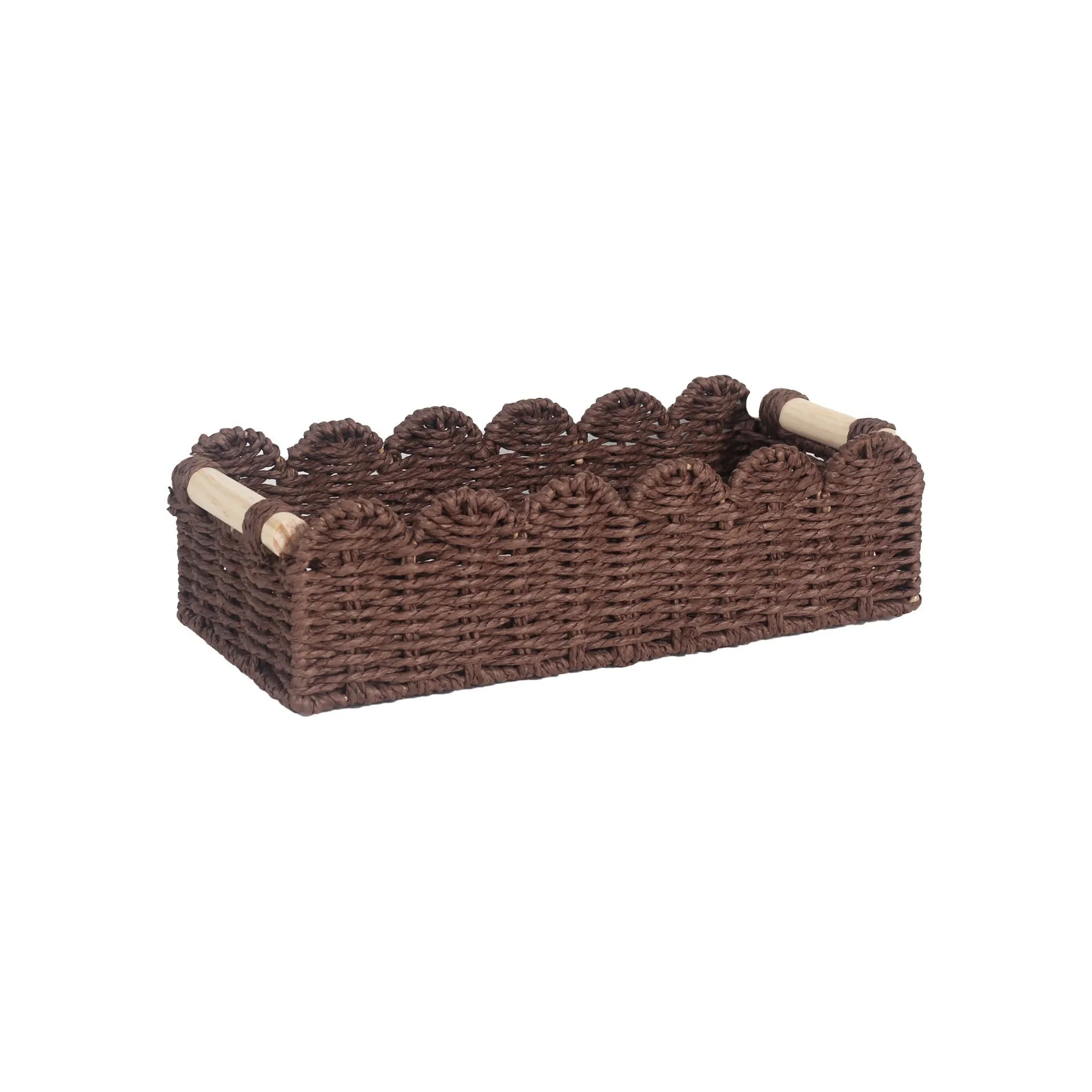 Woven paper storage basket in khaki colour on a desktop, holding remote controls and stationery.