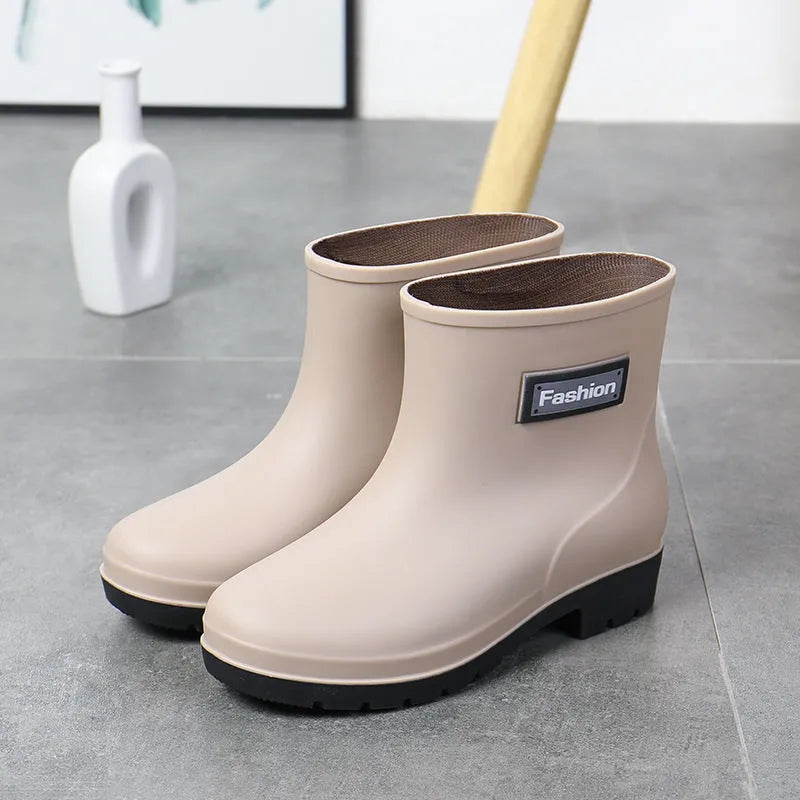 Women's mid-calf PVC rain boot in black, shown with a low heel and optional wool lining.