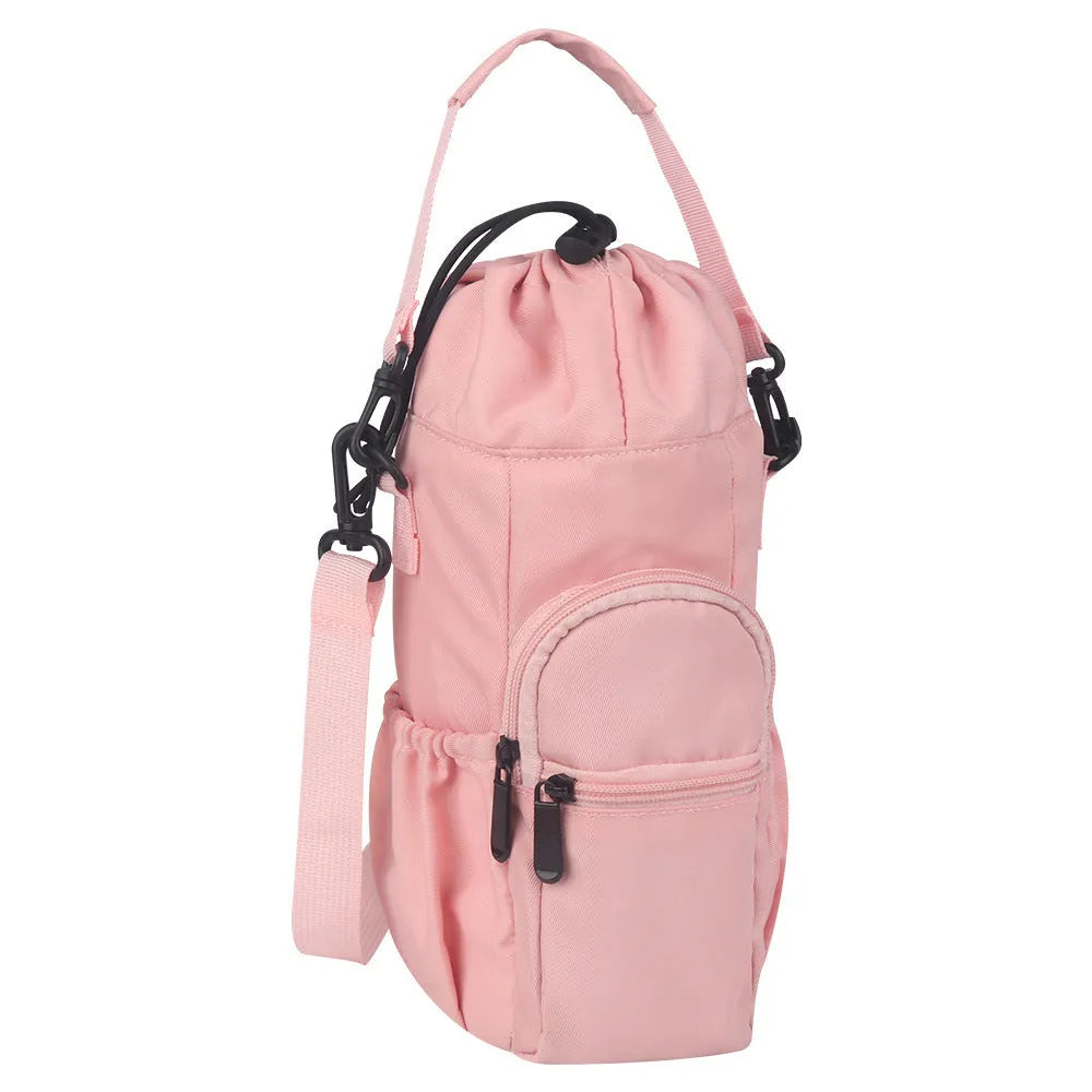 Black cloth water bottle pouch with crossbody strap and side handle on a model.