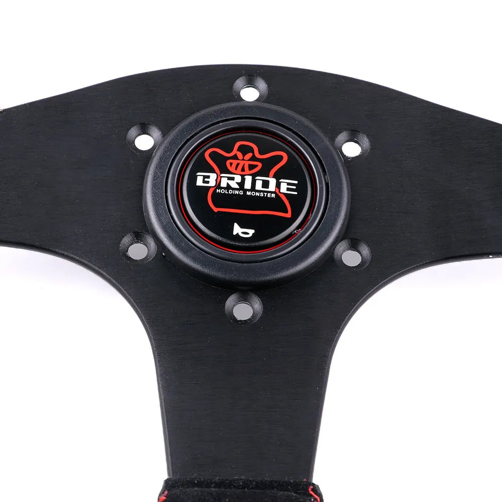 13 inch BRIDE microfiber leather flat steering wheel on black bracket with screw holes visible
