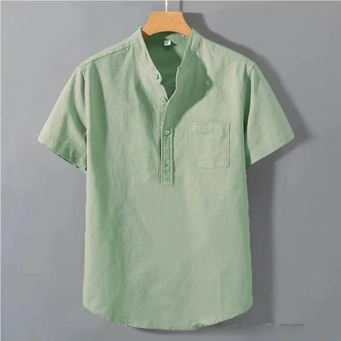 Men's beige loose-fit linen short sleeve shirt with a stand collar on a hanger.