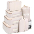 Set of eight PP packing cubes in various colours including beige, black, pink, and leopard print for travel organisation.