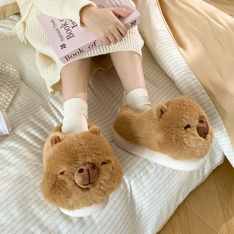 Light brown women's plush winter slippers with cartoon pattern and oversleeve design.