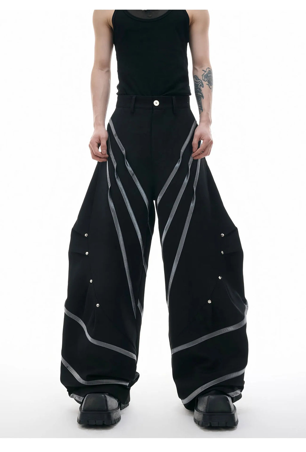 Men's polyester trousers with three-dimensional cut, metal striped rivets, and pleated front.