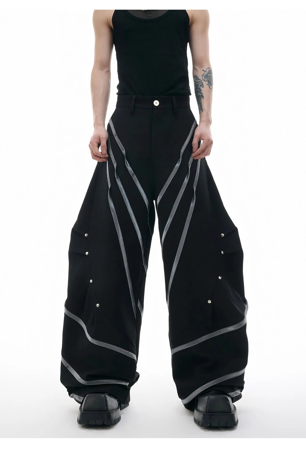 Men's polyester trousers with three-dimensional cut, metal striped rivets, and pleated front.