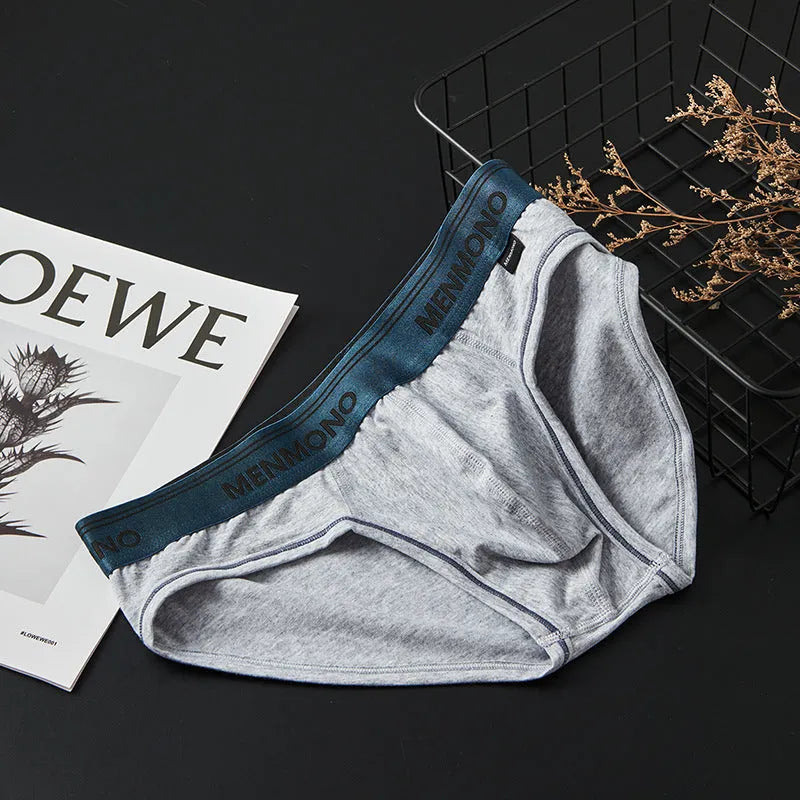 Men's low-waist cotton briefs shown in a two-tone colour combination, such as black with red trim.