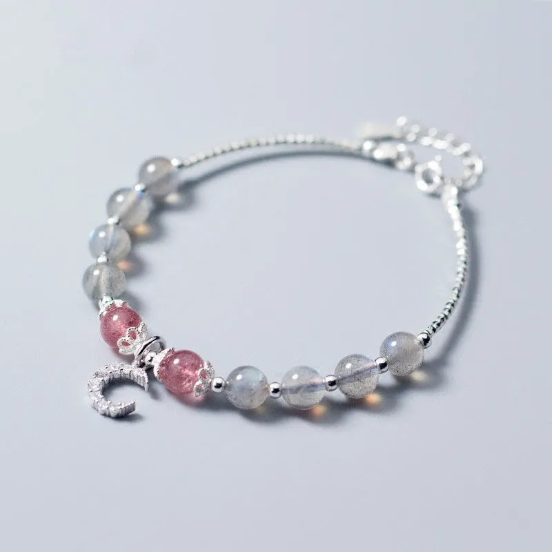 Natural moonstone handmade bracelet with crescent moon charm on wrist showing adjustable clasp