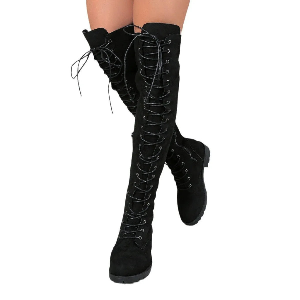 Black over-the-knee lace-up boots with round toe, flat rubber sole, and visible stitching details