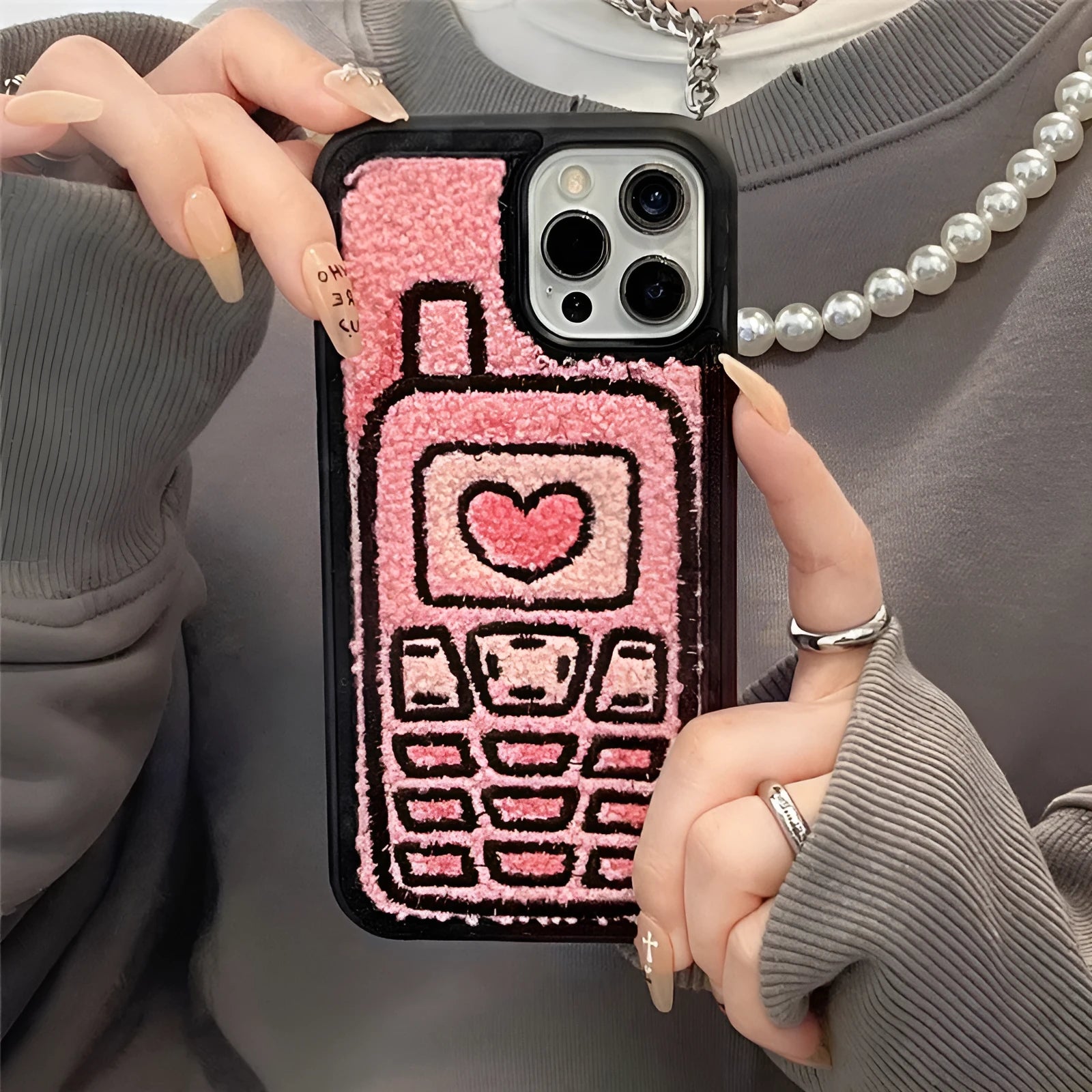 Pink TPU iPhone back case with a unique towel embroidery texture on the rear.