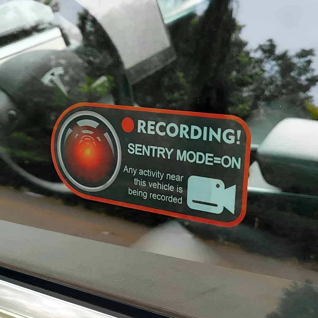 Pair of white electrostatic PVC warning stickers for Tesla car sentry mode, measuring 11 by 5 centimetres.