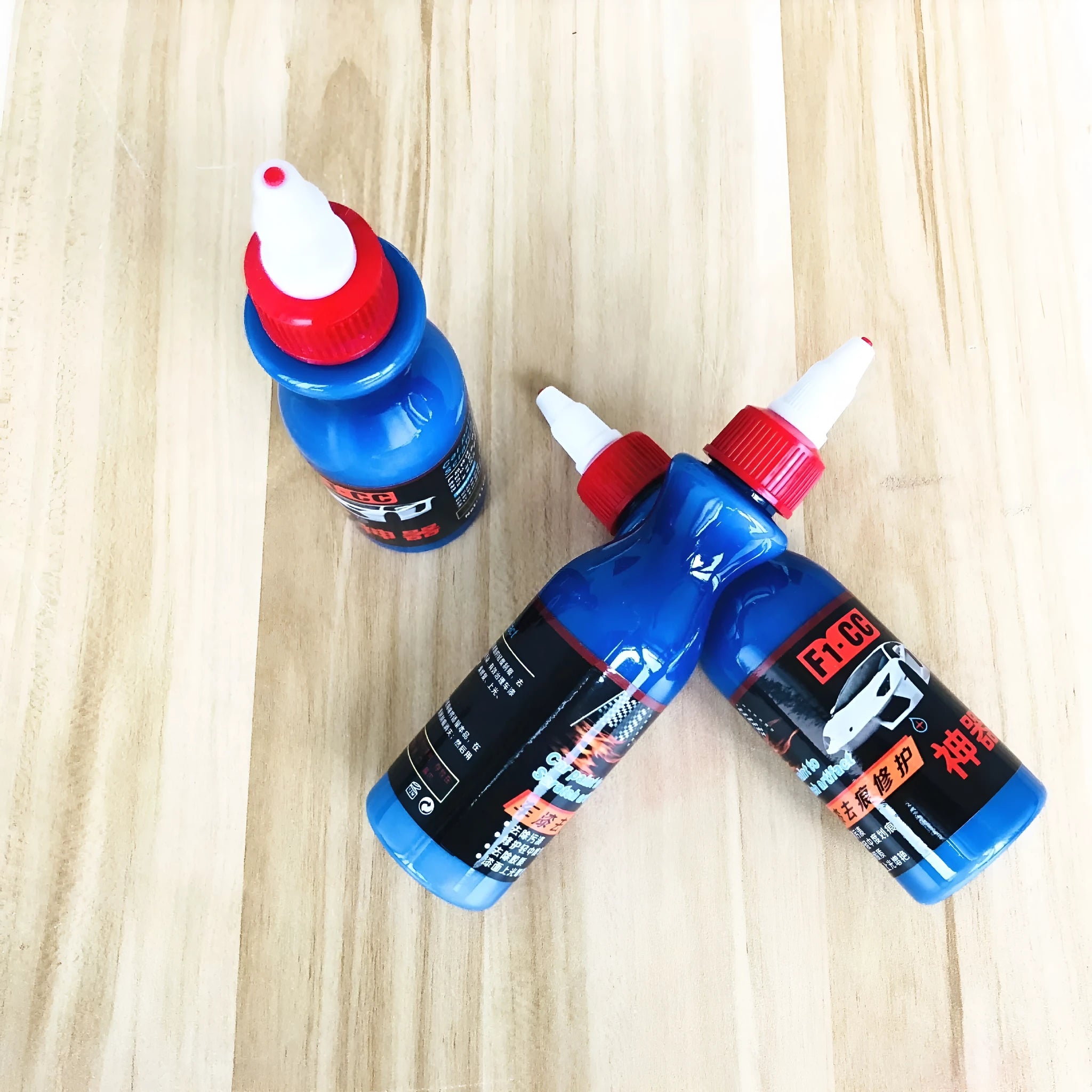 Blue automotive scratch repair agent with wiping tool for car paint restoration