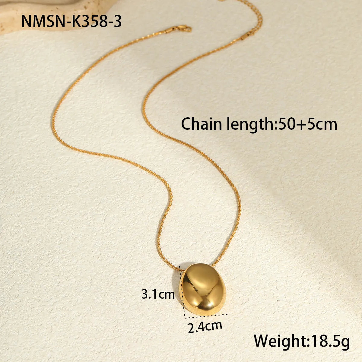 Gold geometric pendant necklace on a model, showing the adjustable chain length.