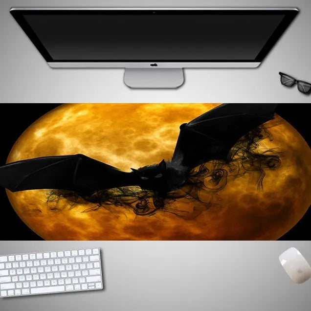 Large Halloween-themed computer mouse pad with graphic design on a desk