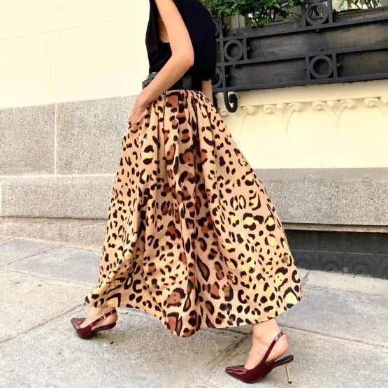 Brown leopard print women's A-line long skirt with a big hem on a hanger.