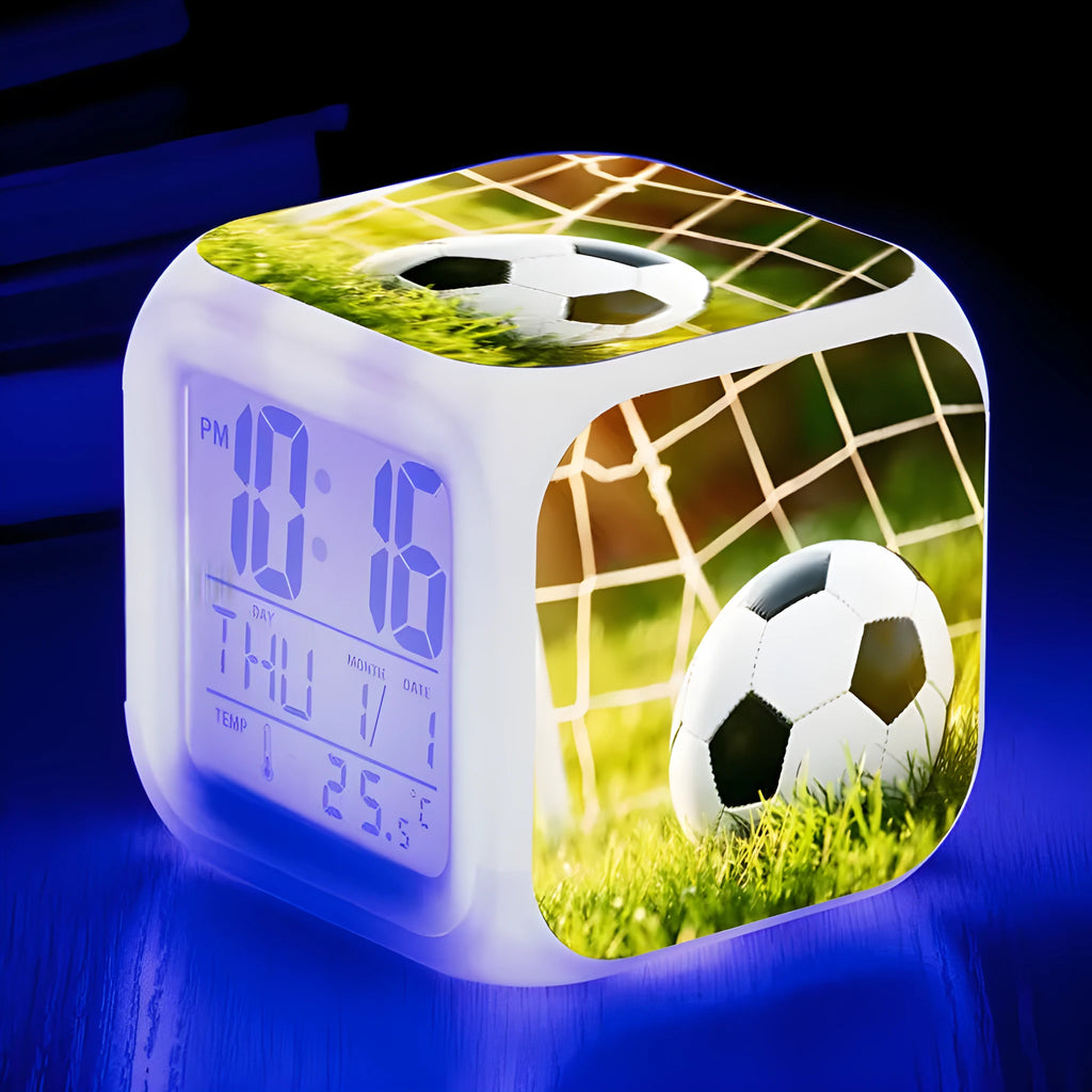 Square plastic alarm clock with a cartoon football pattern, showing silent vibrating alarm models.