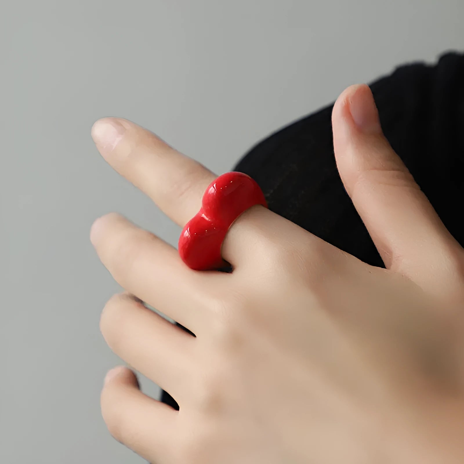 A heart-shaped three-dimensional enamel ring in zinc alloy, shown in one of four available colours.