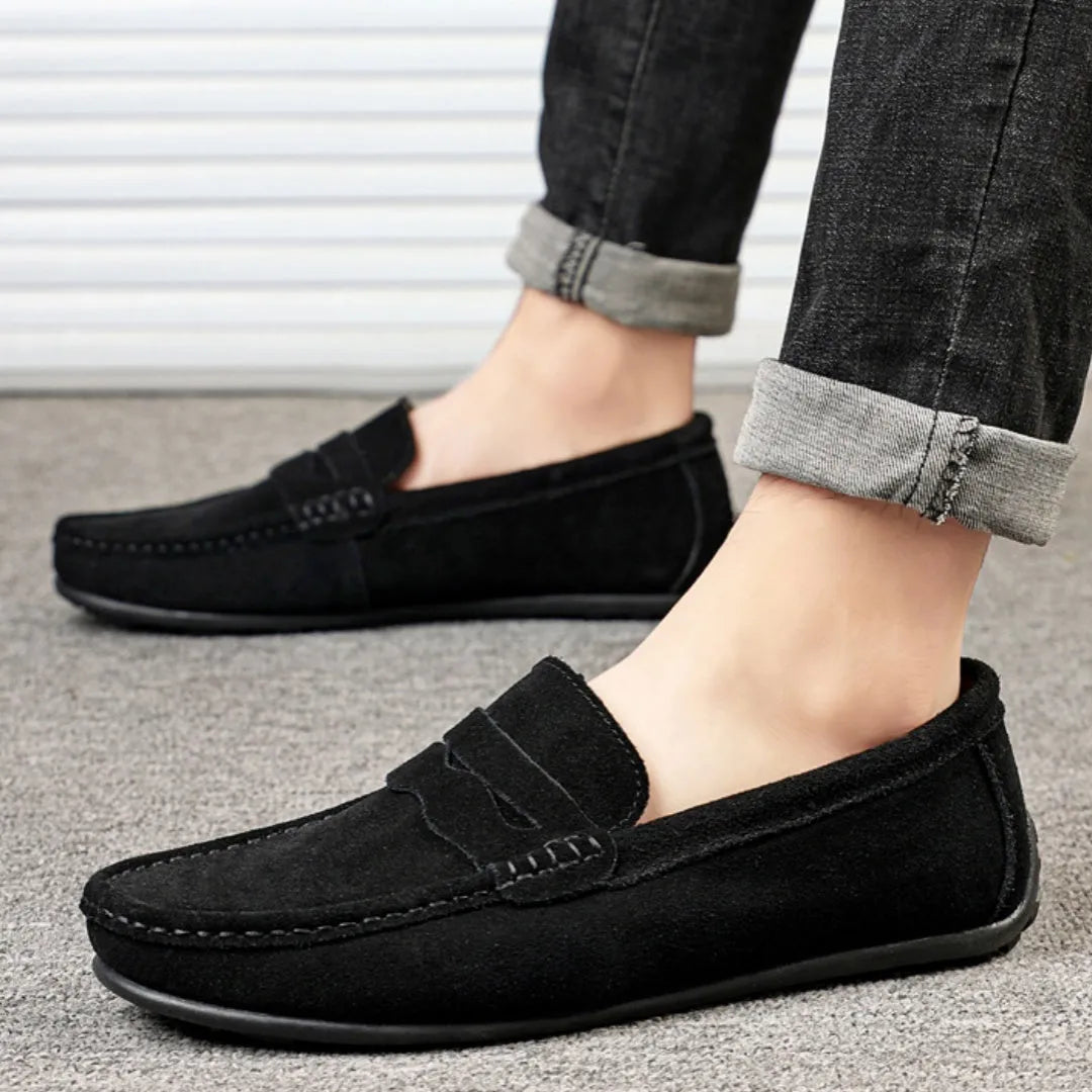 Men's solid colour suede leather slip-on loafers with a flat rubber sole.
