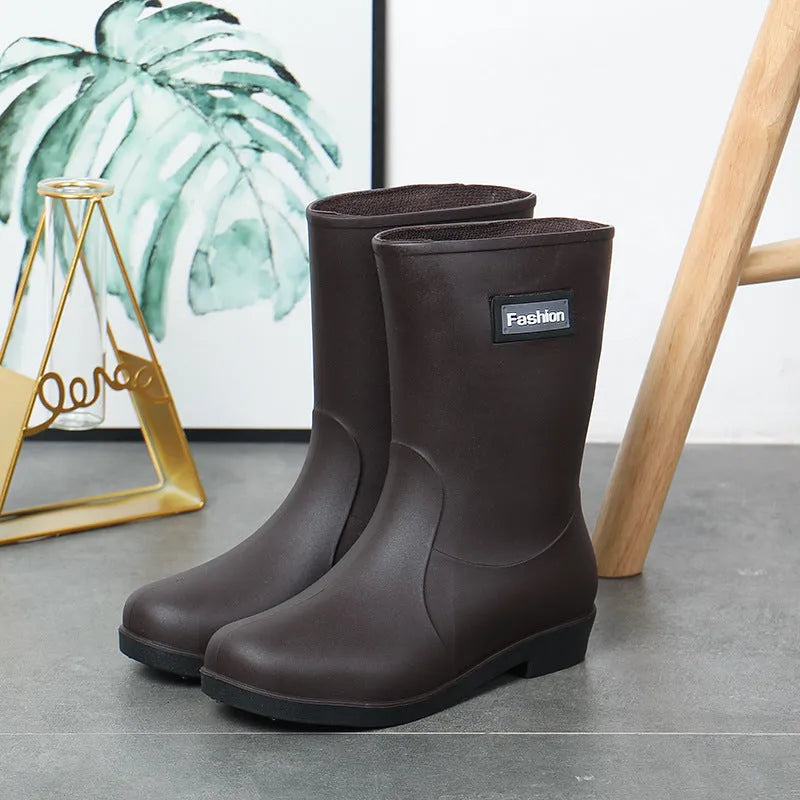 Women's mid-calf PVC rain boot in black, shown with a low heel and optional wool lining.