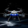 GPS quadrocopter drone with remote controller, spare blades, and landing gear on white background