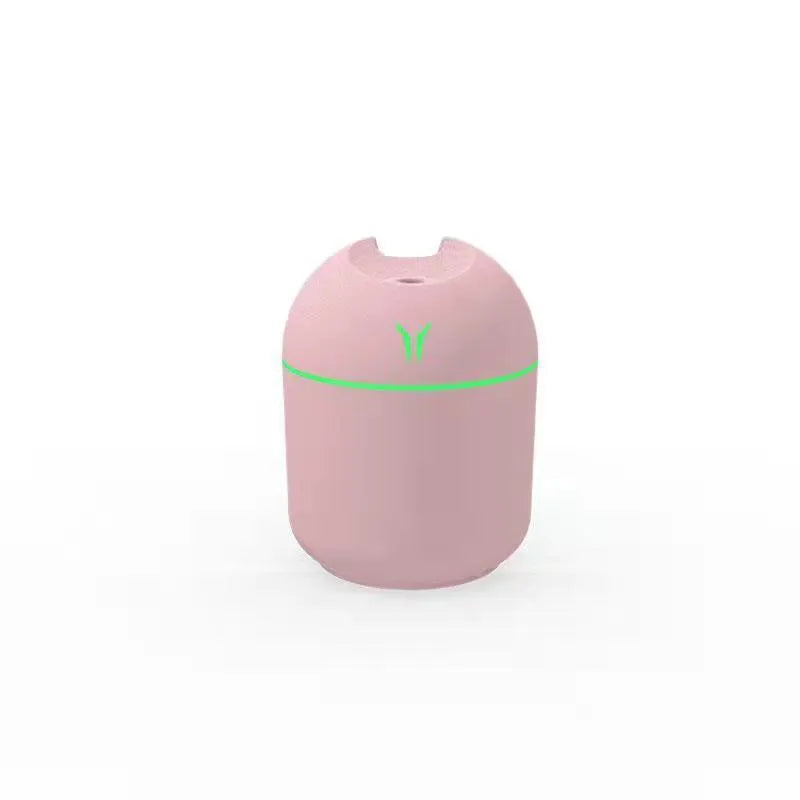 Mini round desktop and car humidifier with USB cable in ivory white, sky blue, or pink.