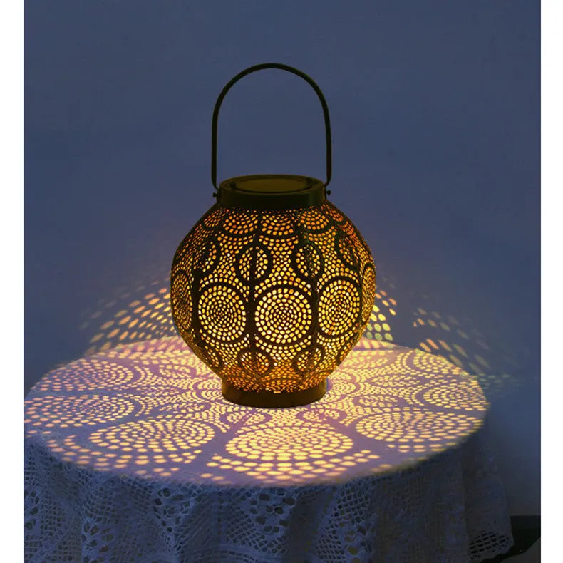 Solar-powered iron courtyard lamp with decorative hollow design and warm white LED lighting