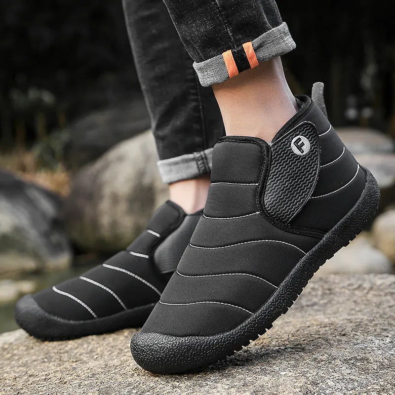 Men's thick cotton snow boots with a non-slip rubber sole in black, shown on a hard surface.