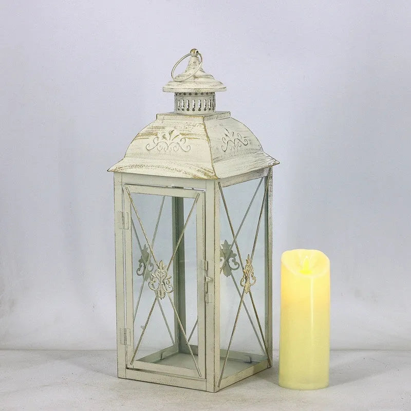 Black wrought iron floor-standing storm lantern with tempered glass panels for outdoor candle lighting