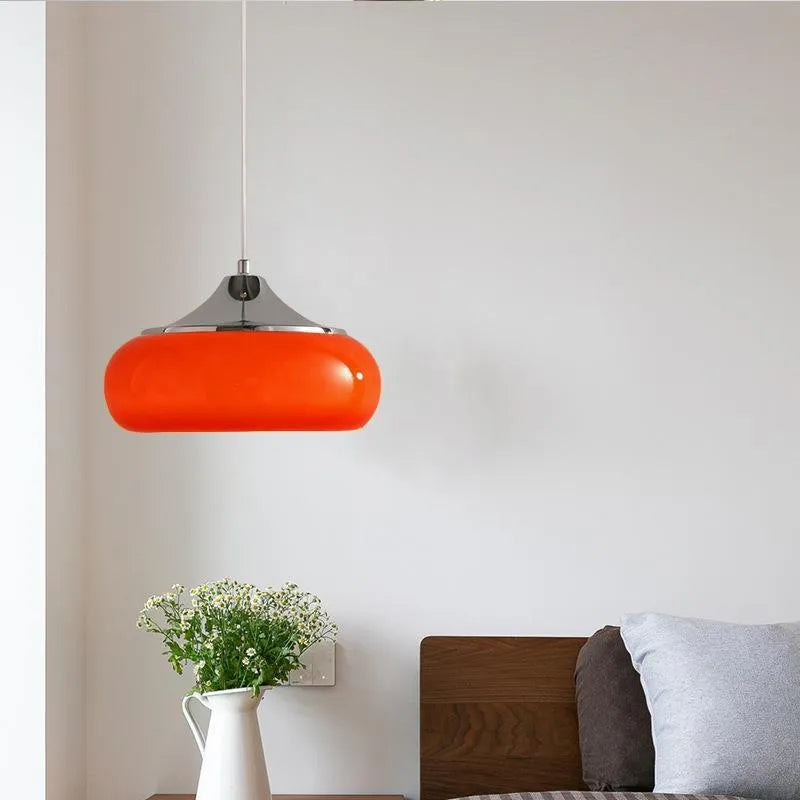 Three-headed Bauhaus pendant light with milky white glass egg tart shades hanging from a ceiling.