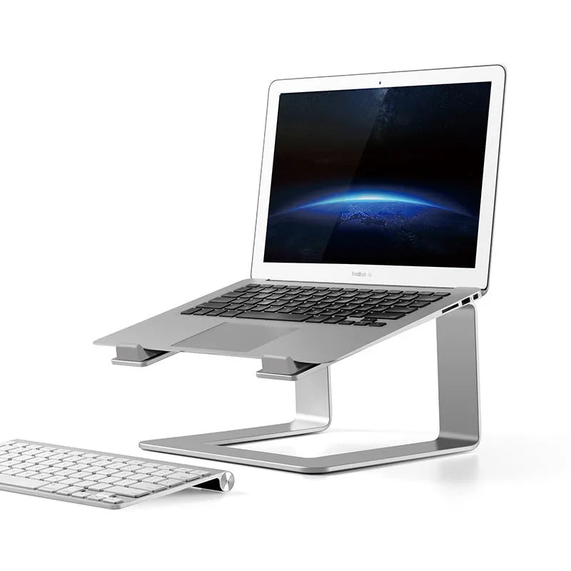Black aluminium laptop stand on desk supporting silver laptop at improved viewing height