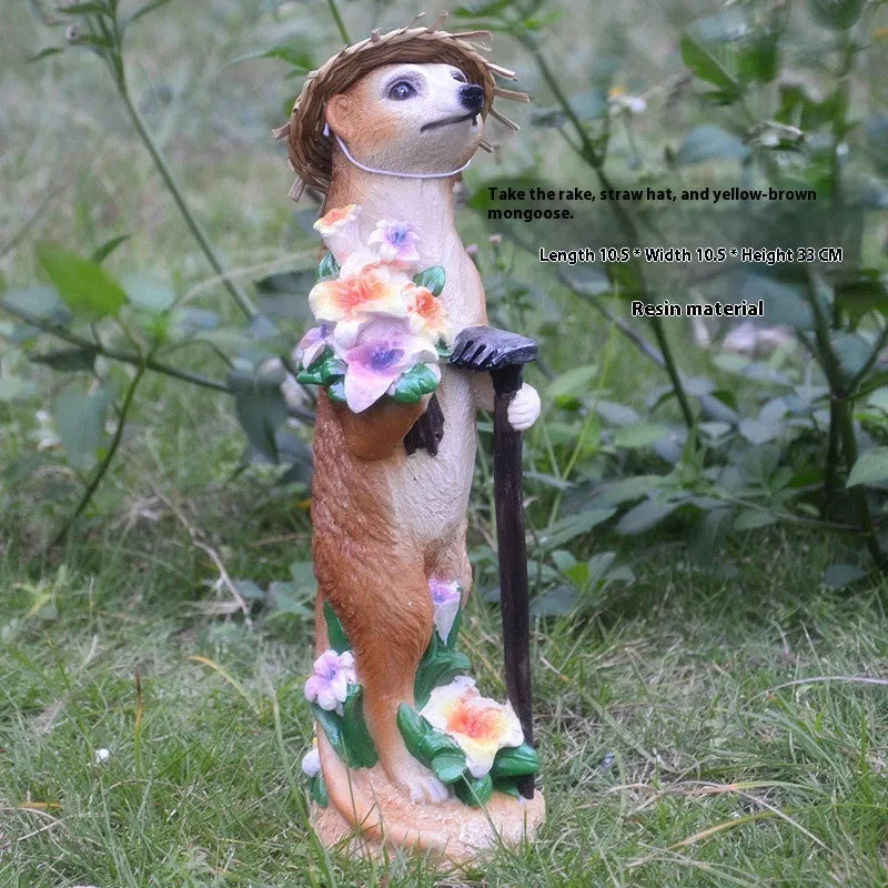 Three small straw hat mongoose garden ornaments: one with a baby, one holding a rake, one holding a shovel.