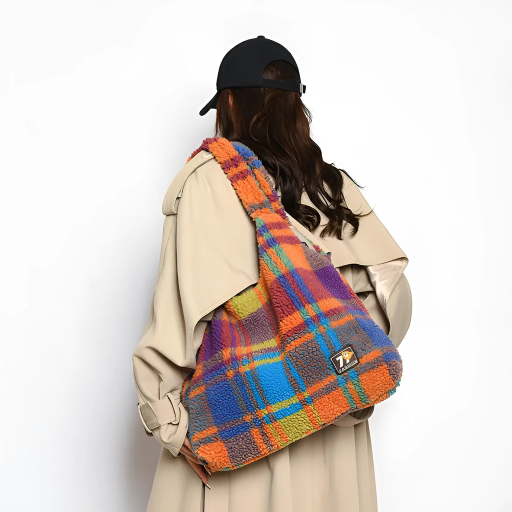 Women's plaid pattern crossbody tote bag showing soft plush material and horizontal square shape with crossbody strap.
