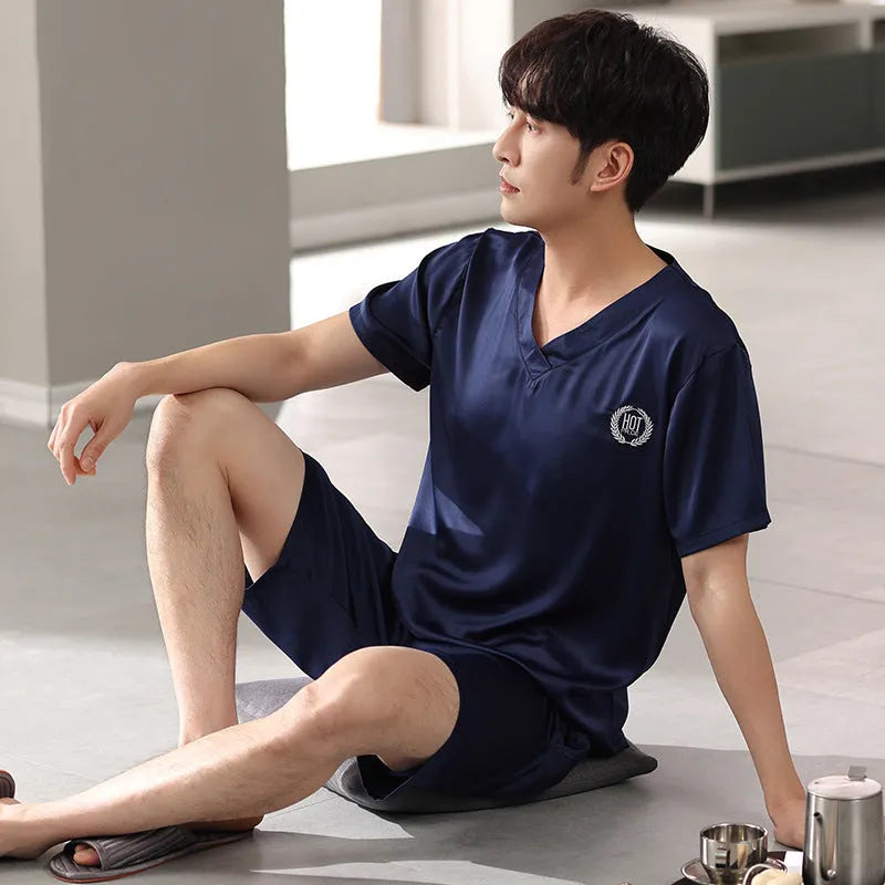 Man wearing a loose grey ice silk short-sleeve pajama shirt and matching shorts.