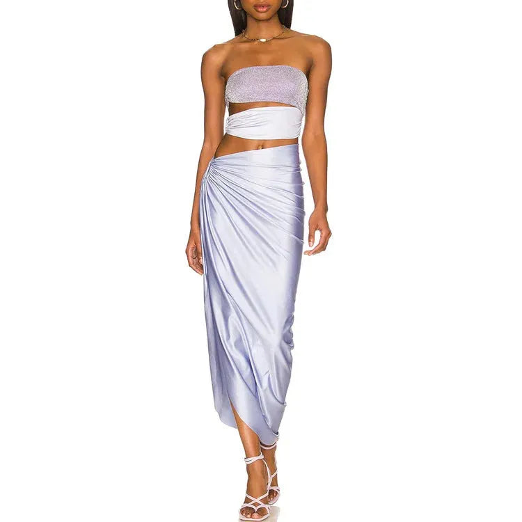 Purple one-piece swimsuit with coordinating wrap skirt set on beach background