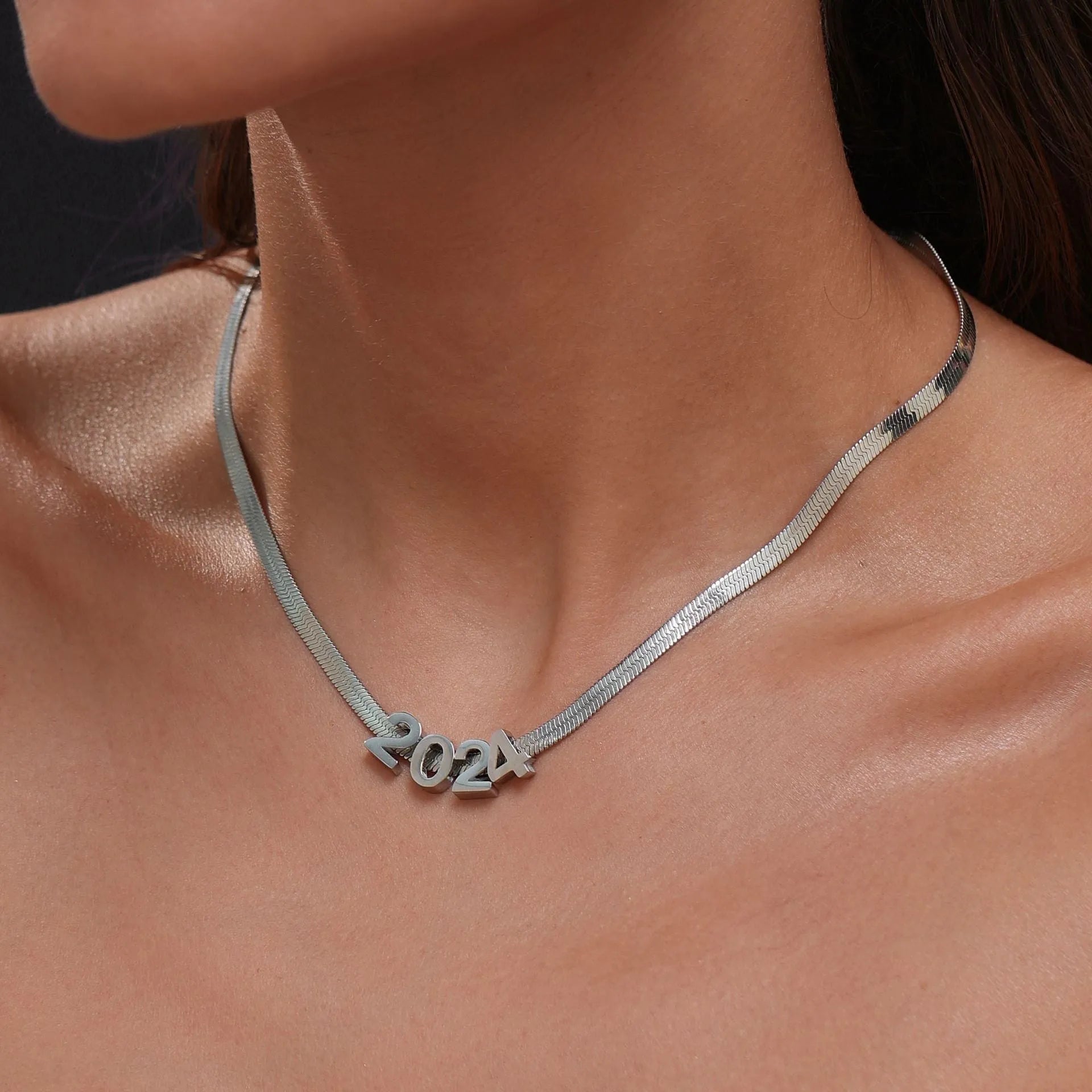 Gold or silver titanium steel necklace with a personalised letter, number, or heart pendant on a 40.5cm chain.