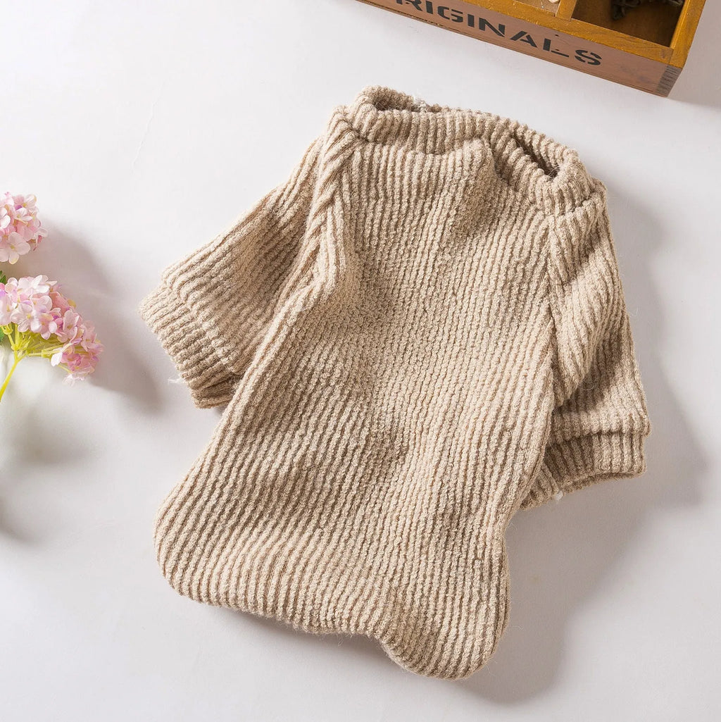 Brown cloth pullover dog sweater on a small breed dog.