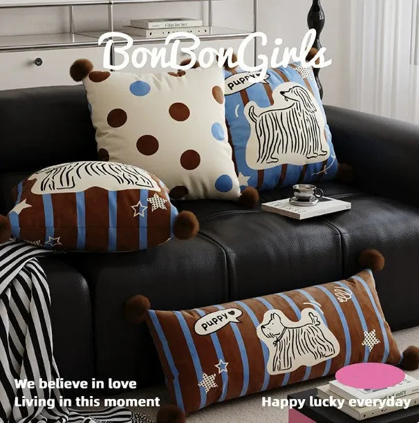 Blue cartoon animal print sofa cushion pillow on a grey sofa.