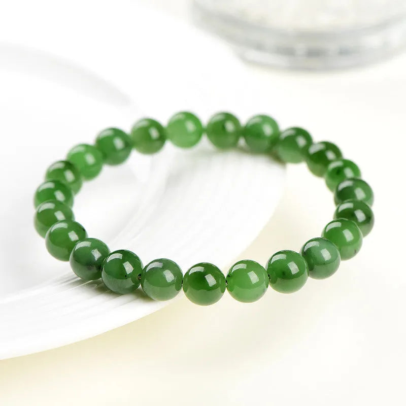 Polished natural Jasper Hetian jade bead bracelet on wrist, showing bead detail.