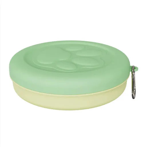 Portable outdoor dog food and water bowl with attached snack box in light pink and green colours.