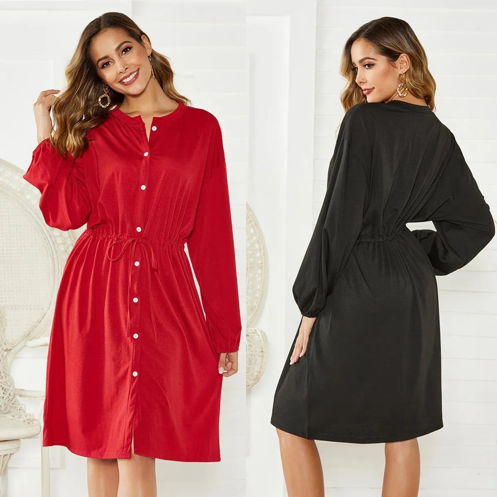 A woman wearing a solid colour midi dress with an elastic waist, long sleeves, and a loose belt.