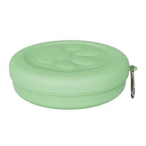 Portable outdoor dog food and water bowl with attached snack box in light pink and green colours.