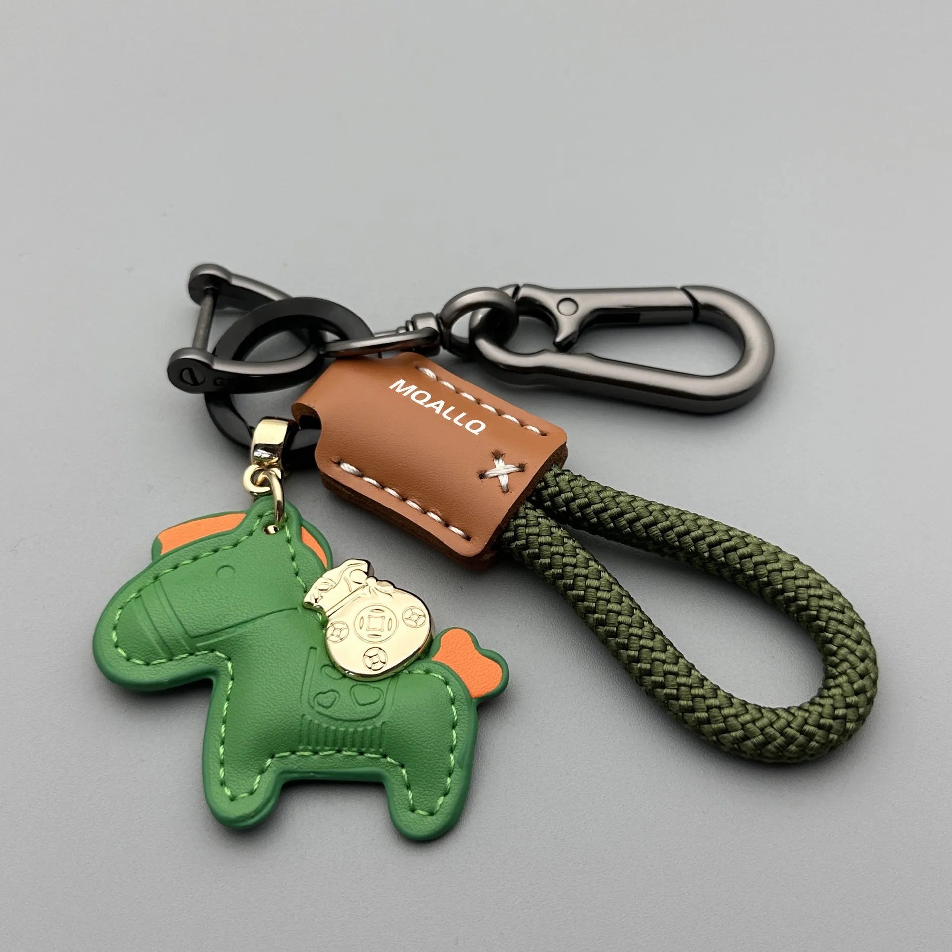 Handmade brown cowhide car key pendant with green flanelle rope and a metal buckle.