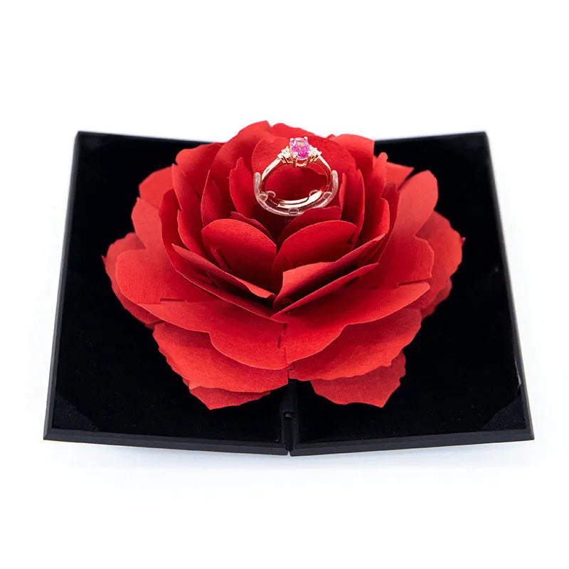 3D Love Box heart-shaped rotating rose flower ring box in red plastic on white background