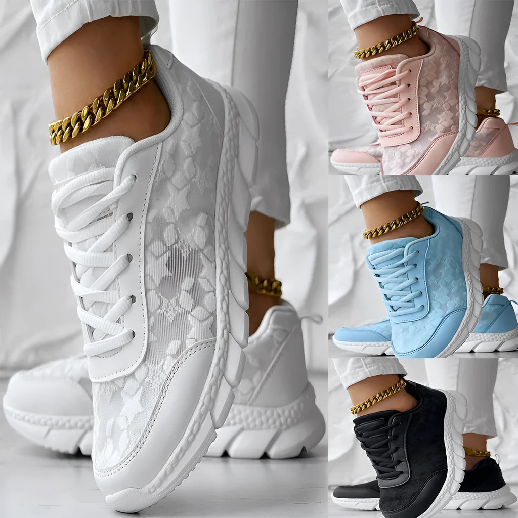Women's white canvas running shoes with soft sole and flat heel on a plain background.