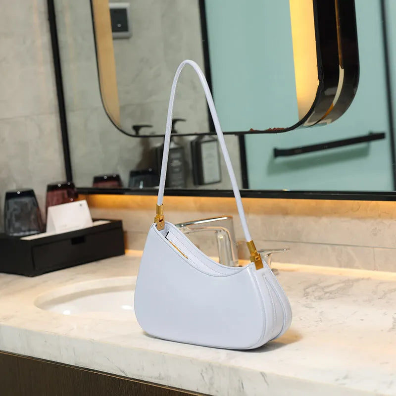 Women's retro oval PU leather shoulder bag in seven colour options with single strap and internal zipper compartment