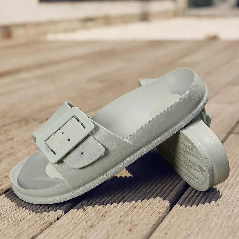Women's grey blue EVA flip-flops with a buckle strap on a soft sole.