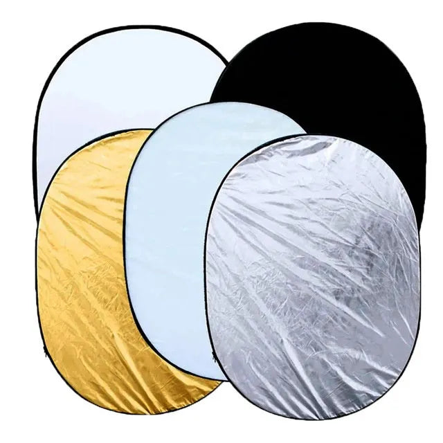 Open and folded 5-in-1 collapsible photography light reflector showing gold, silver, white, black, and translucent surfaces.